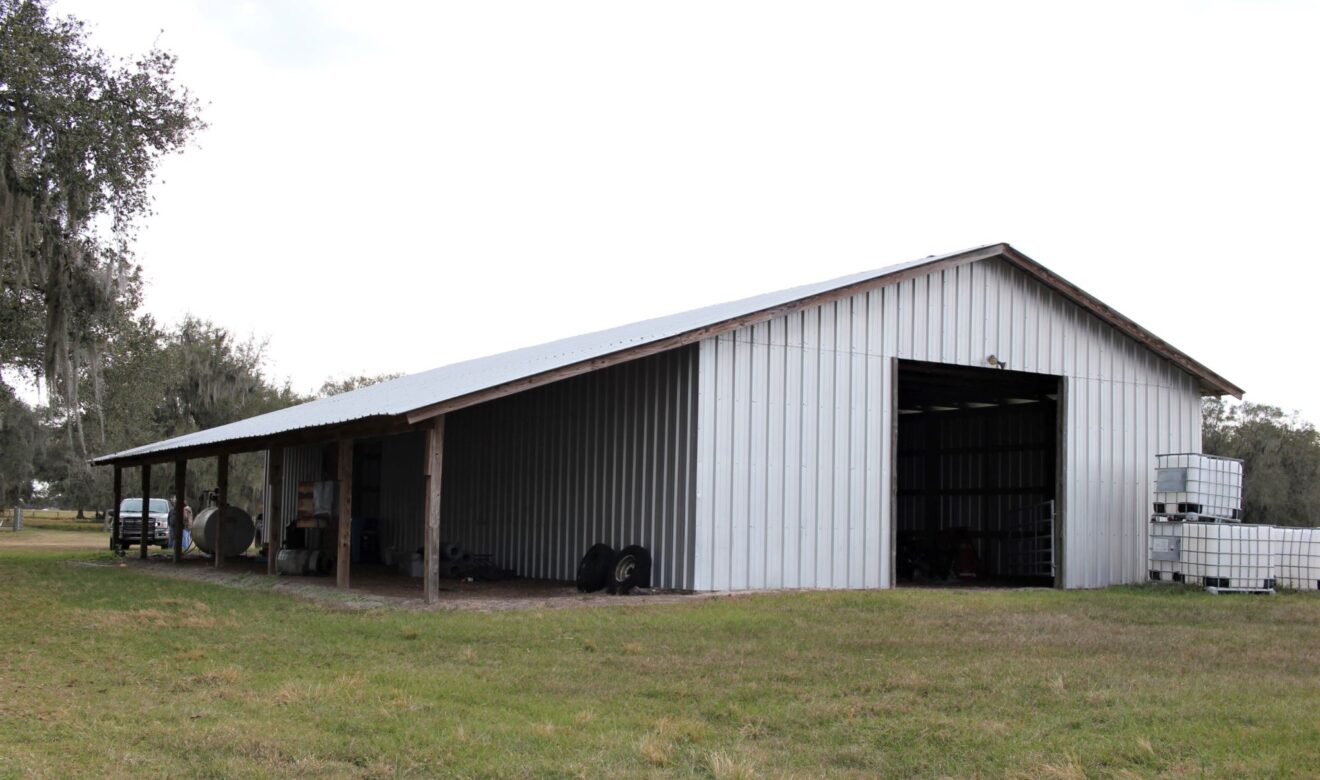 70 x 36 enclosed metal pole barn, with a 12 x 70 overhang on the north side